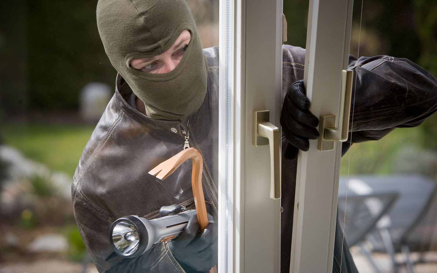 burglar breaking into a home